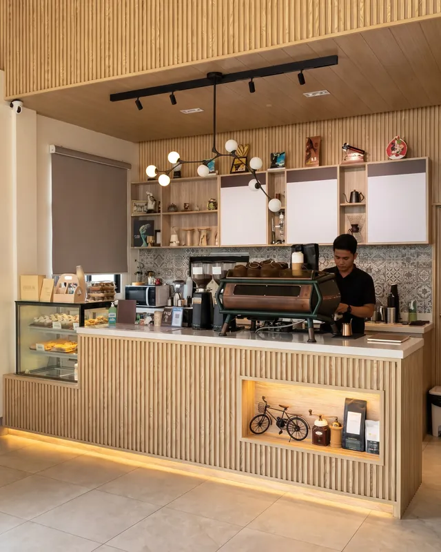A barista at Manna's fluted oak coffee bar